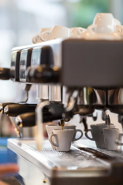 Professional coffee machine making espresso.