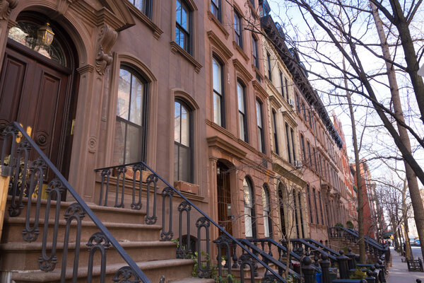 Old houses with stairs in the historic district of West Village, Manhattan, New York.