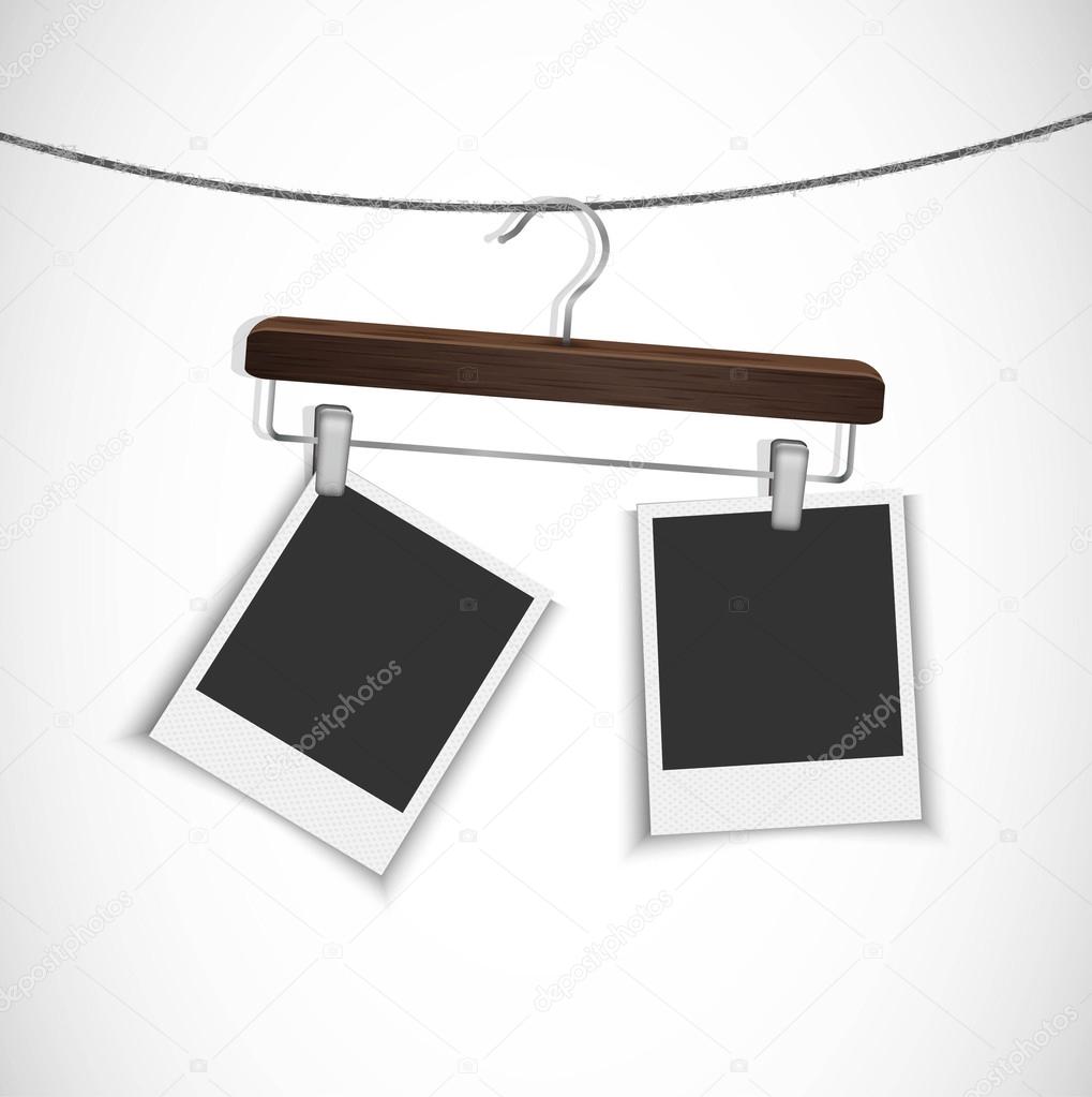 Blank photo frame hanging on a rope with clothes hanger