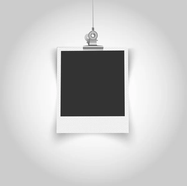 Empty polaroid frame with bulldog clip