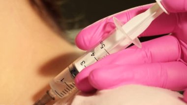 Enjeksiyon işlemi. Macro, şırınga iğnesini yavaş çekimde kapat. Aşı enjeksiyonu. Doktor İğne Kullanıyor. Sağlık ve tıbbi kavramlar. Kızıl Efsane Ejder Kamerası ile çekim yap.