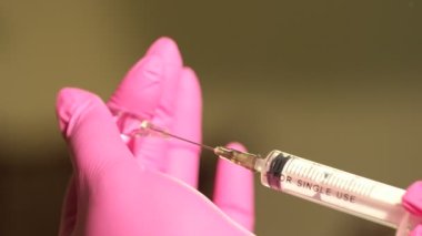 Enjeksiyon işlemi. Macro, şırınga iğnesini yavaş çekimde kapat. Aşı enjeksiyonu. Doktor İğne Kullanıyor. Sağlık ve tıbbi kavramlar. Kızıl Efsane Ejder Kamerası ile çekim yap.