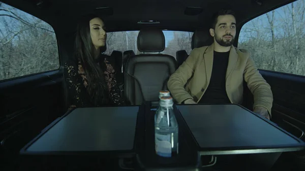 Young guy and a young girl are sitting in the car. Them Talking each other and admire. Couple in love in the car.Photo, still, image.