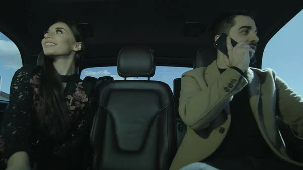 Young guy and a young girl are sitting in the car. Them Talking each other and admire. Couple in love in the car.Photo, still, image.