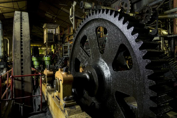 Huge cog wheel in industrial hall