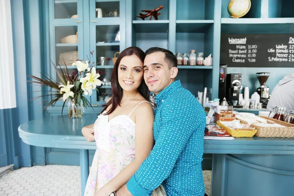 Portrait of happy young couple in cafeteria — Stock Photo, Image