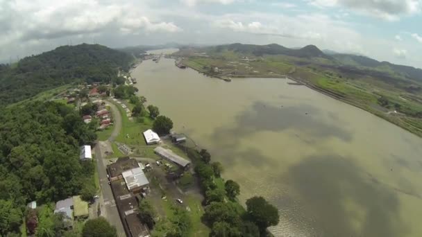Aerial View of The Panama Canal, is a 77.1-kilometre (48 mi) ship canal in Panama that connects the Atlantic Ocean (via the Caribbean Sea) to the Pacific Ocean. — Stock Video