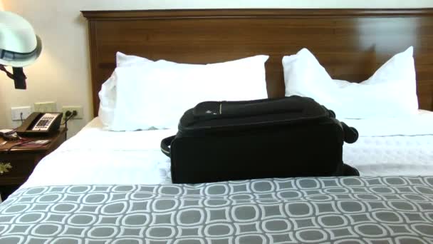 Man putting things in bedroom ready to be taken on summer holiday. — Stock Video