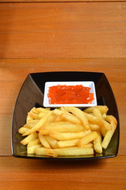 ahşap masa üzerinde biber ve domates soslu patates kızartması