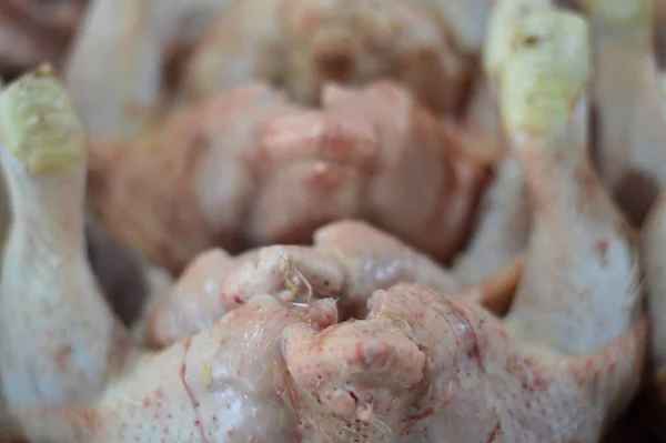 raw dead chicken at the market with selective focus