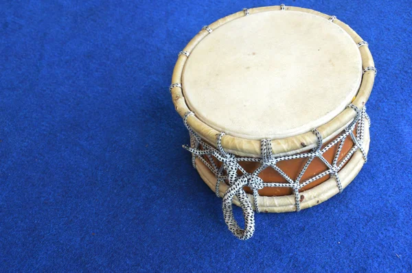 Traditional drum on the blue carpet — Stock Photo, Image