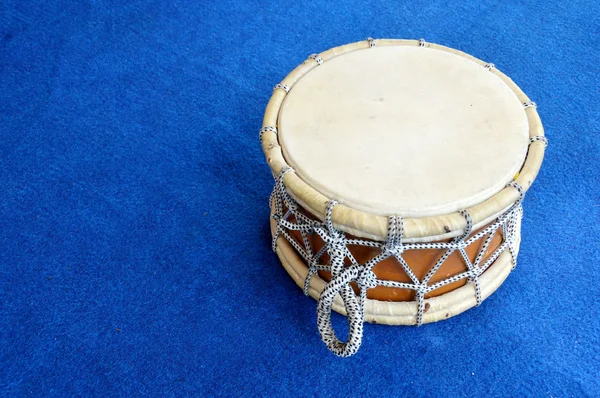 Traditional drum on the blue carpet — Stock Photo, Image
