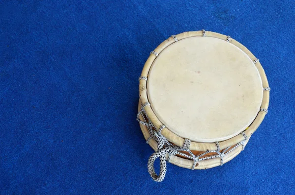 Traditional drum on the blue carpet — Stock Photo, Image