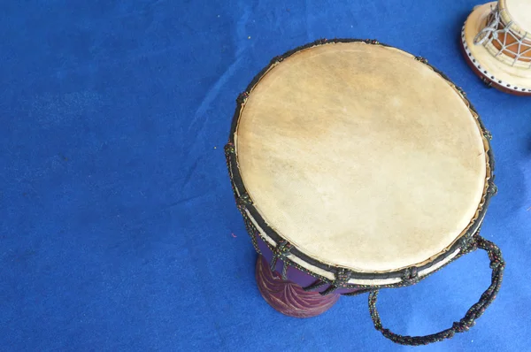 Traditional drum on the blue carpet Royalty Free Stock Photos