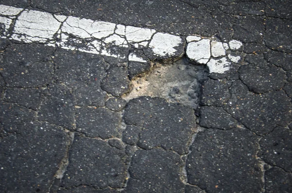 Damaged asphalt road — Stock Photo, Image