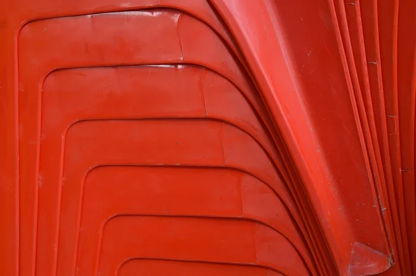 Farbabstrakt auf den roten Stapeln von Plastikstühlen — Stockfoto