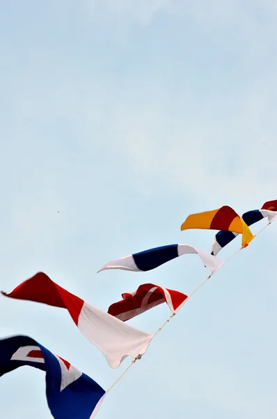 Maritime flags against blue sky — Stock Photo, Image