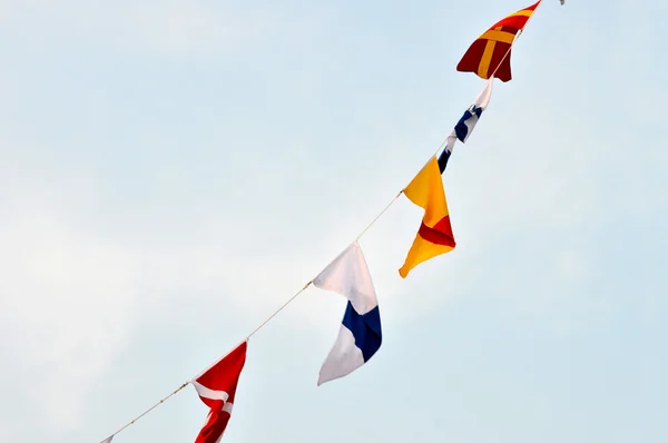 Maritime flags against blue sky — Stock Photo, Image