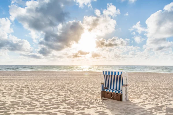 One Beach Chair on a beach at sundown