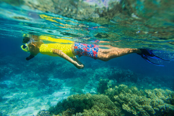 Boy dives in a tropical sea