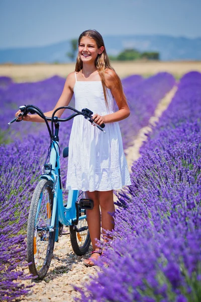 Girl in lavender field with a bike — Stock Photo, Image