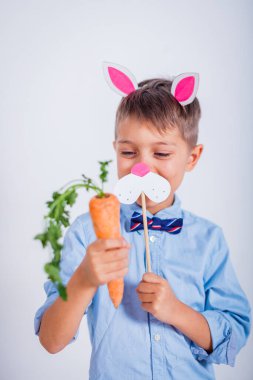 Gri arka planda tavşan kulaklı şirin bir çocuk.