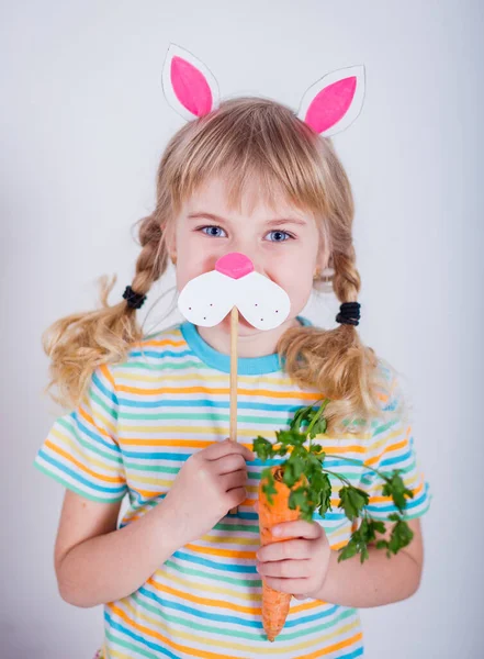 Cute little girl with bunny ears on gray background