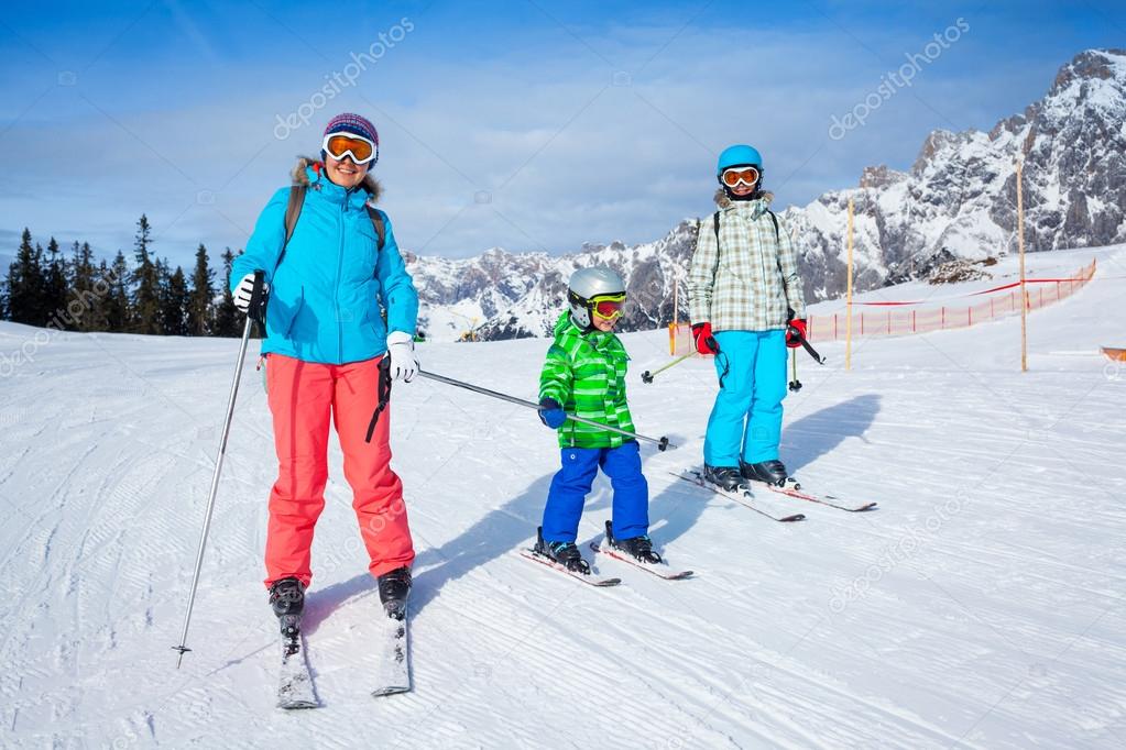 Two kids with mother enjoying winter vacations.