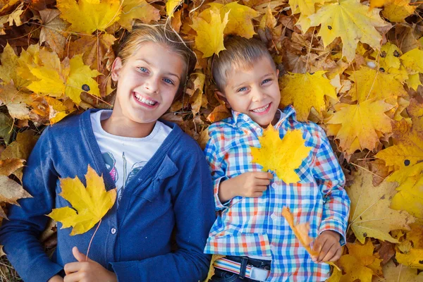 Lindo chico y chica en el parque de otoño — Foto de Stock