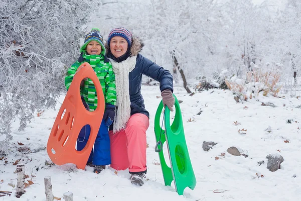 Familie plezier met slee in winter park — Stockfoto