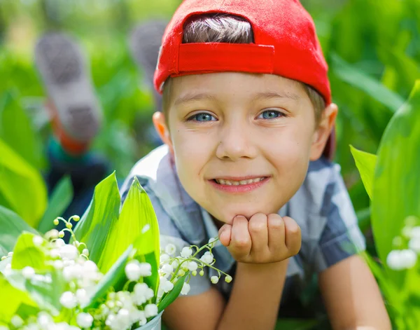 Boy with lilies of the valley — Stock Photo, Image