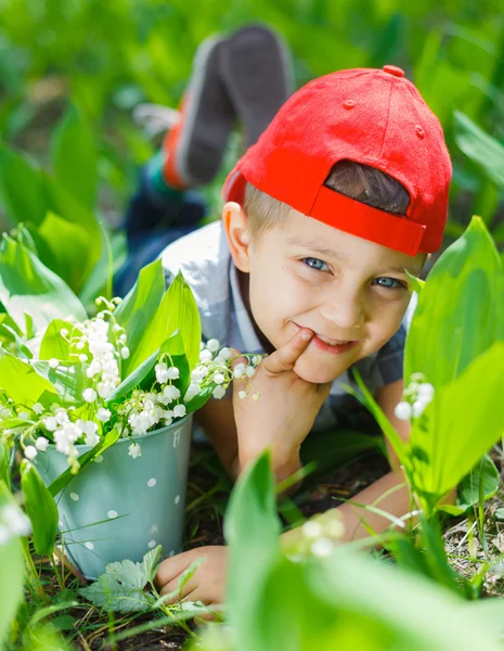 Boy with lilies of the valley — Stock Photo, Image