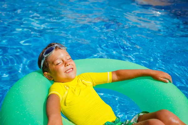 Pojke simmar i en pool — Stockfoto