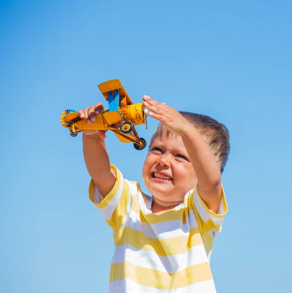 Junge spielt mit Flugzeug — Stockfoto