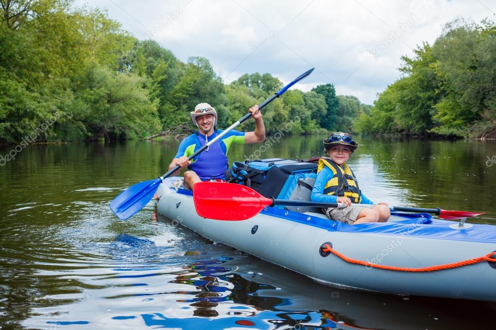 Boy with his father kayaking