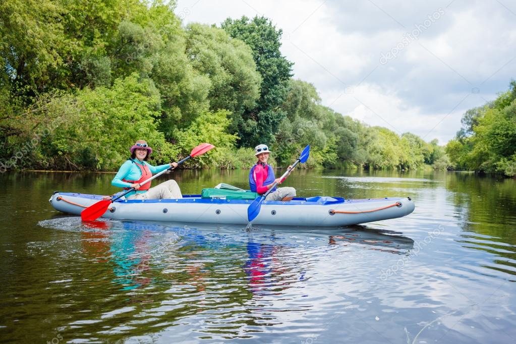 Girl with her mother kayaking