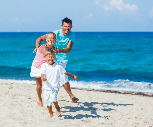 Kinder und Vater spielen am Strand. — Stockfoto