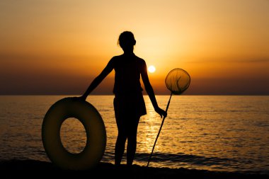 Girls silhouette on beach