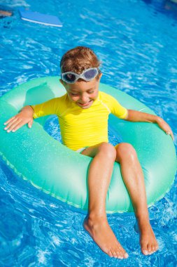 Little boy relax in pool