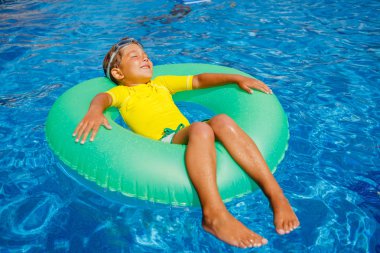 Little boy relax in pool