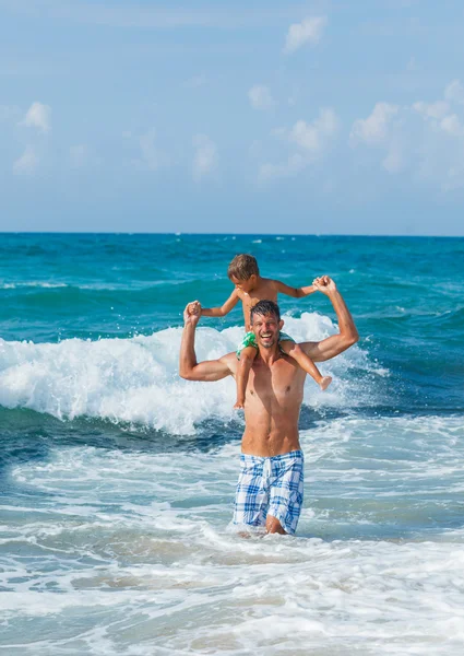 Pai e filho brincando no mar — Fotografia de Stock