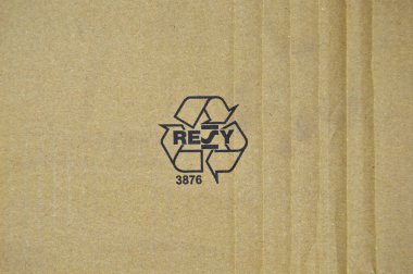Brown and beige colored cardboard detail, black recycle sign on paper clipart