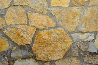 Sağlam sarı ve bej kesimli taş duvar, arka planlar için iyi, düzgün sıralanmış.