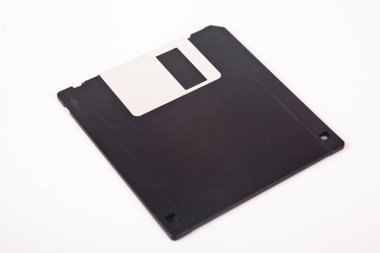 Eski bilgisayar ve veri depolama teknolojisi, siyah plastik manyetik disk 3.5 inç, beyaz arka planda izole edilmiş.