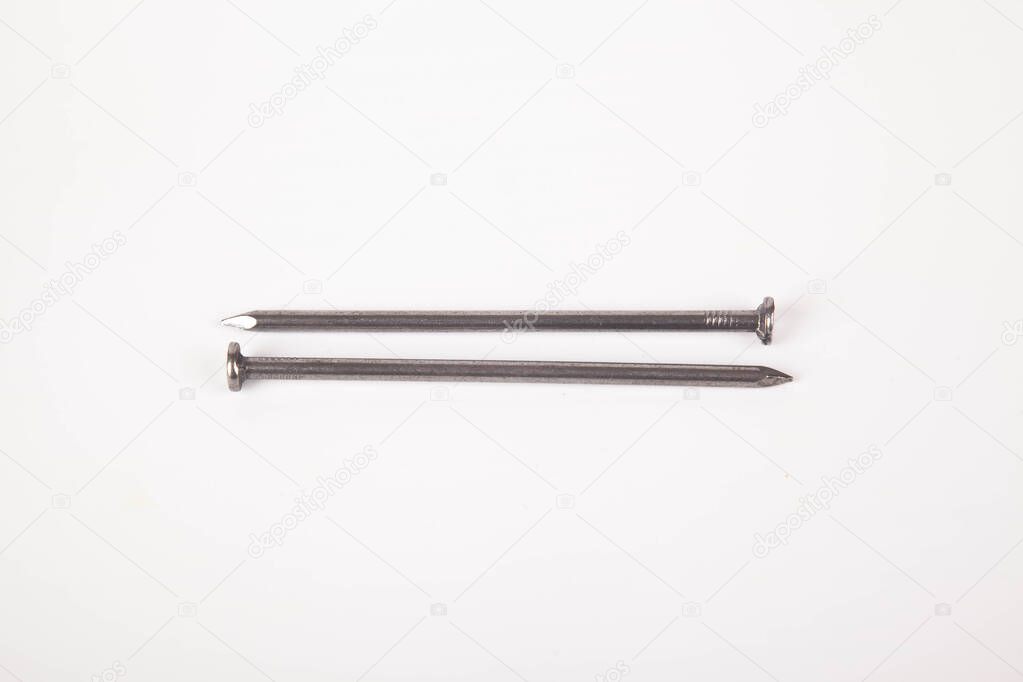 A lot of construction iron nails, industrial parts, isolated on white background