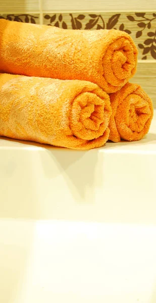 Three Orange Rolled Towels Ceramic Sink Luxurious Clean Bathroom — Stock Photo, Image