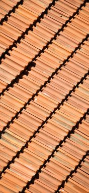 Red terracotta tiles of a building, repetitive roof texture background architectural