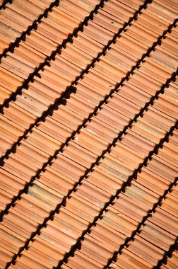 Red terracotta tiles of a building, repetitive roof texture background architectural
