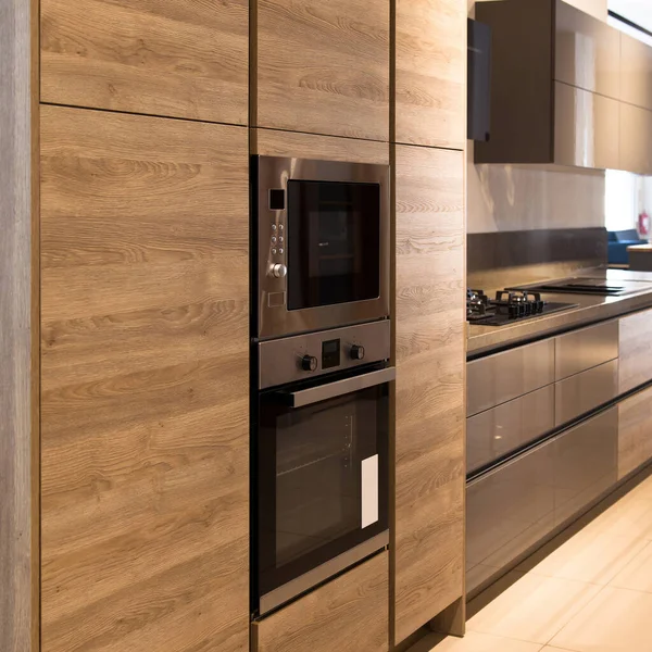 Interior of luxurious modern kitchen equipment and oak grey cabinets