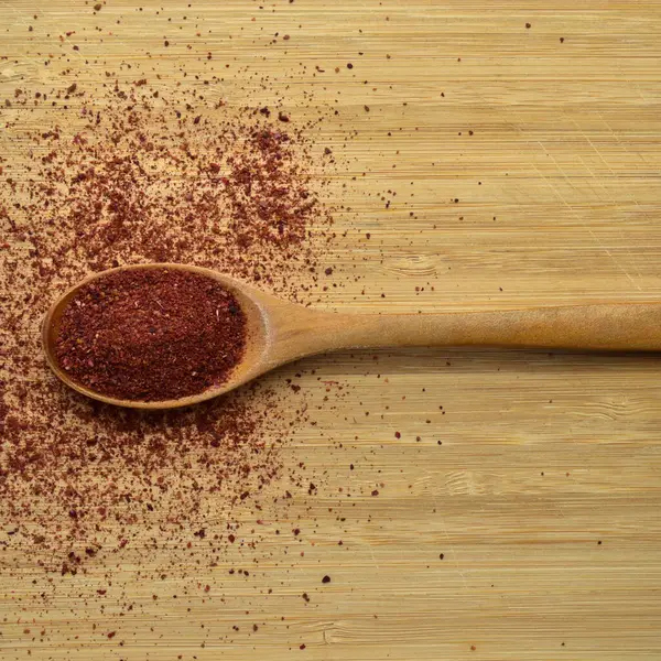 Tahta Kaşık Içinde Bambu Kesme Tahtasının Üzerinde Organik Aromalı Sumak — Stok fotoğraf